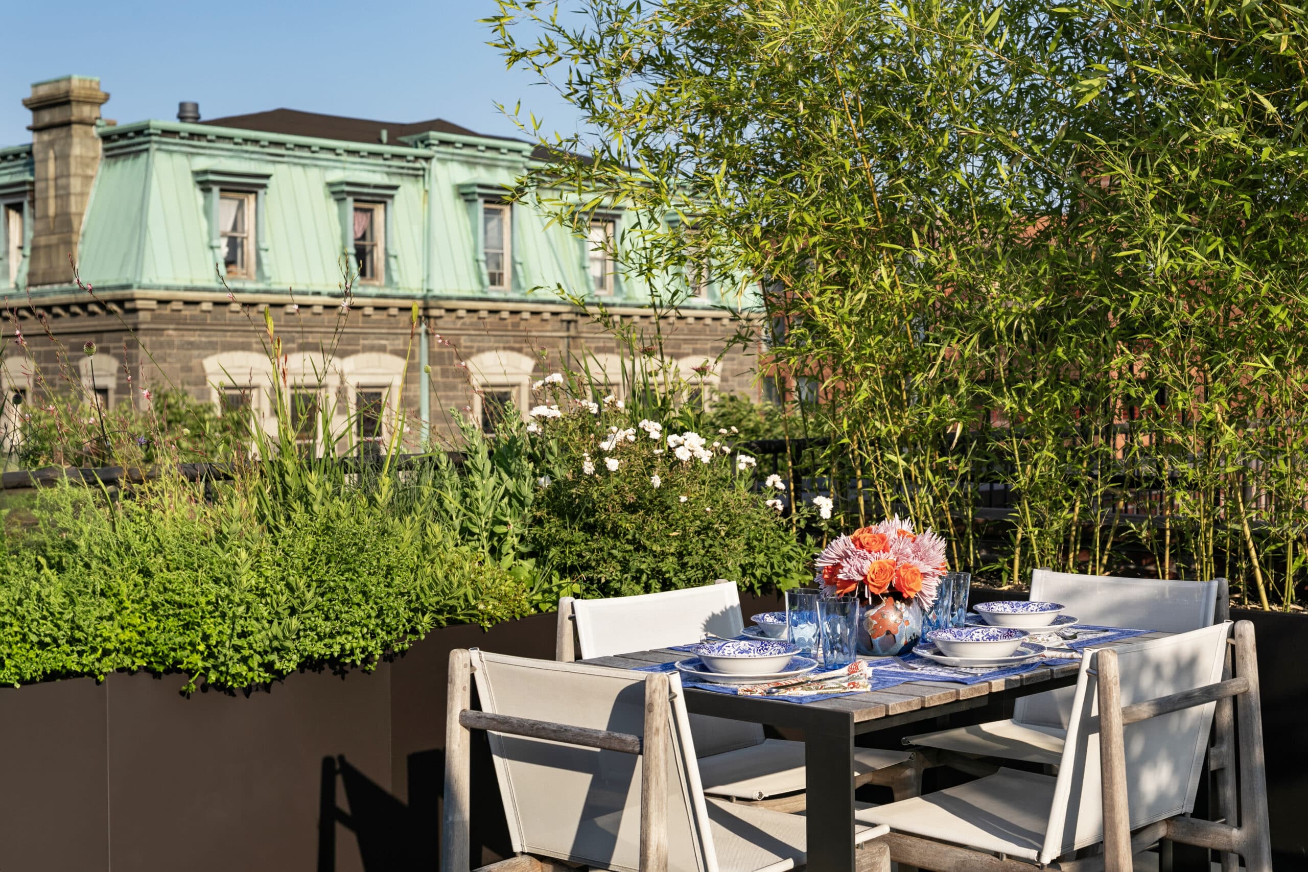 ROOFTOP DINING AREA WITH MANSARD BUILDING IN BACKGROUND