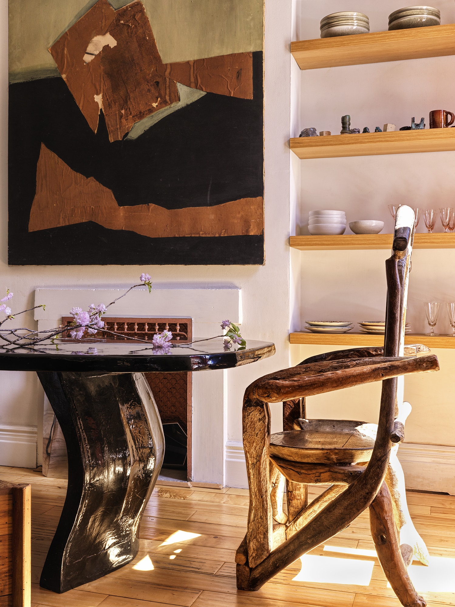 BOOKSHELVES WITH TABLE PAINTING AND WOOD CHAIR
