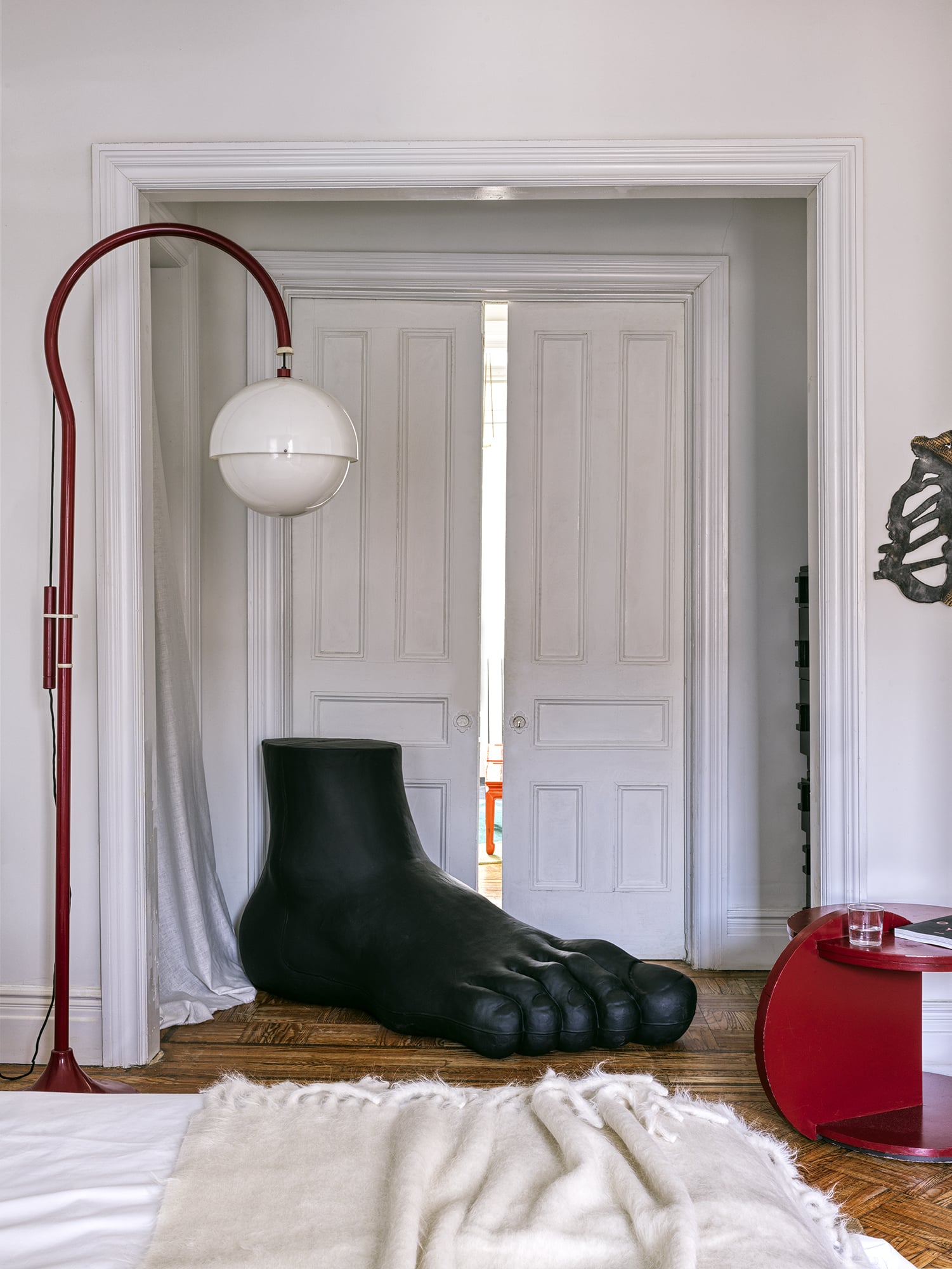 DOUBLE DOORS WITH FOOT SCULPTURE AND WHITE GLOBE STANDING LAMP