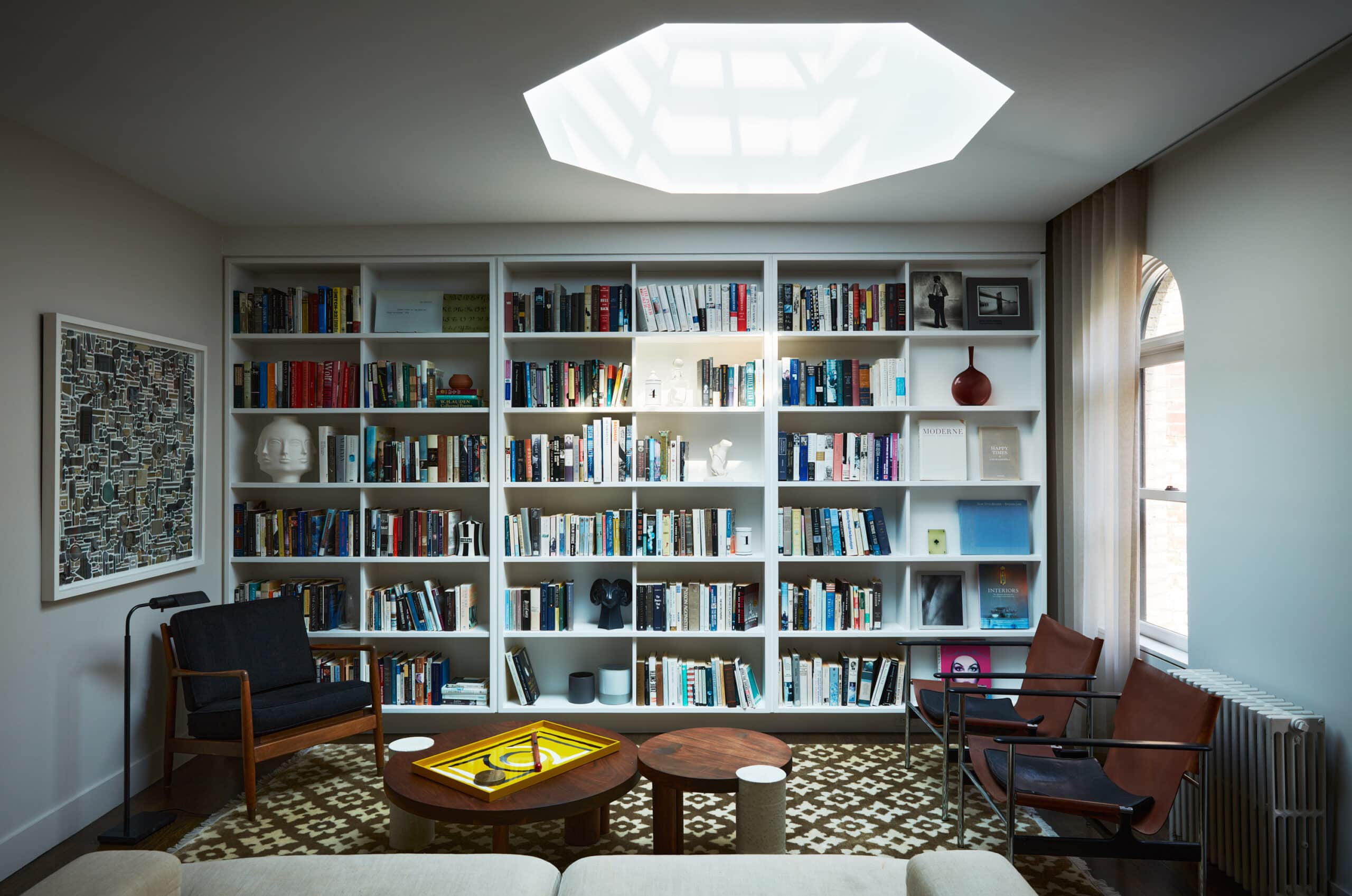 LIVING ROOM BOOKSHELVES AND PYRAMID SKYLIGHT
